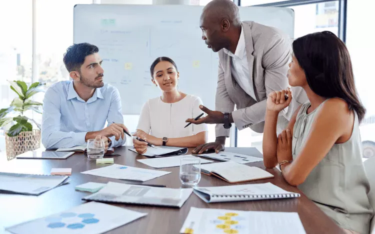 Business professionals discussing strategies during a team meeting.