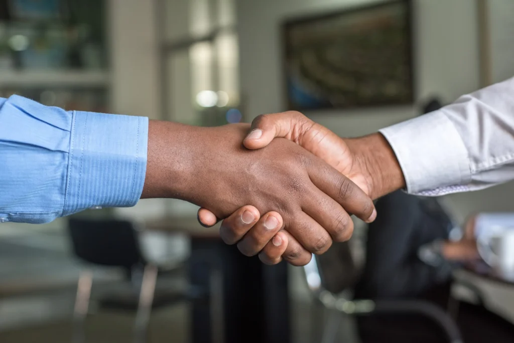 Business professionals shaking hands to seal a successful partnership.
